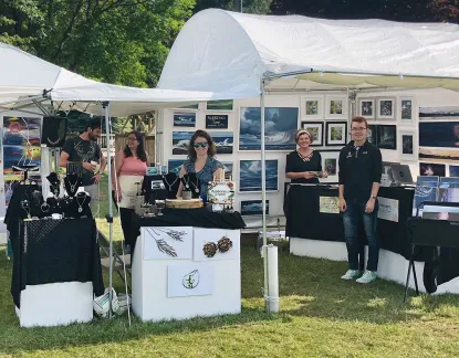 Art students setting up a booth at a local art fair