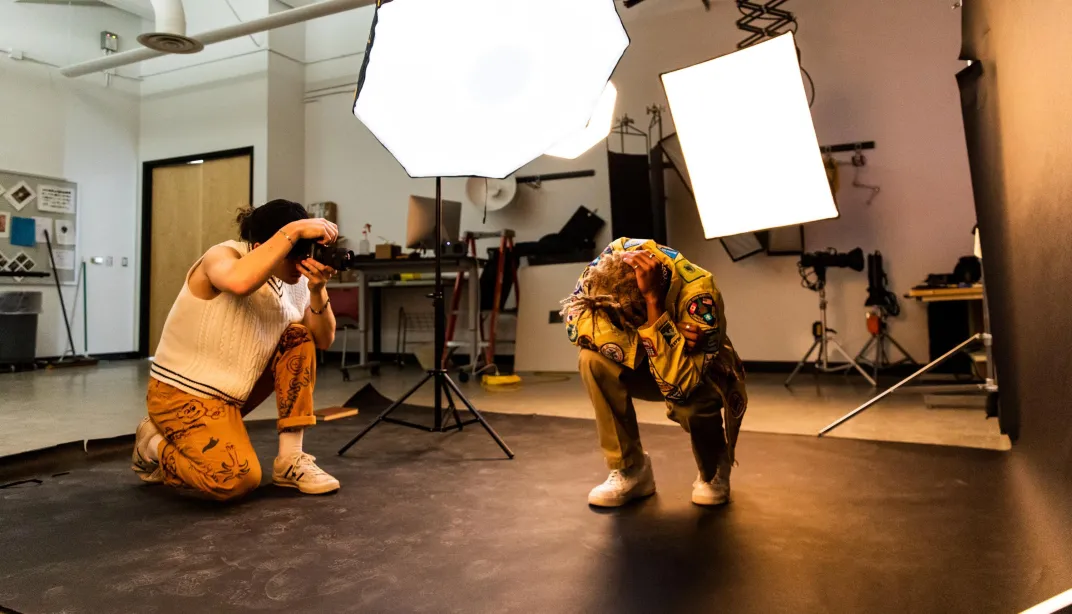 Photographer and subject in an NMU photo studio